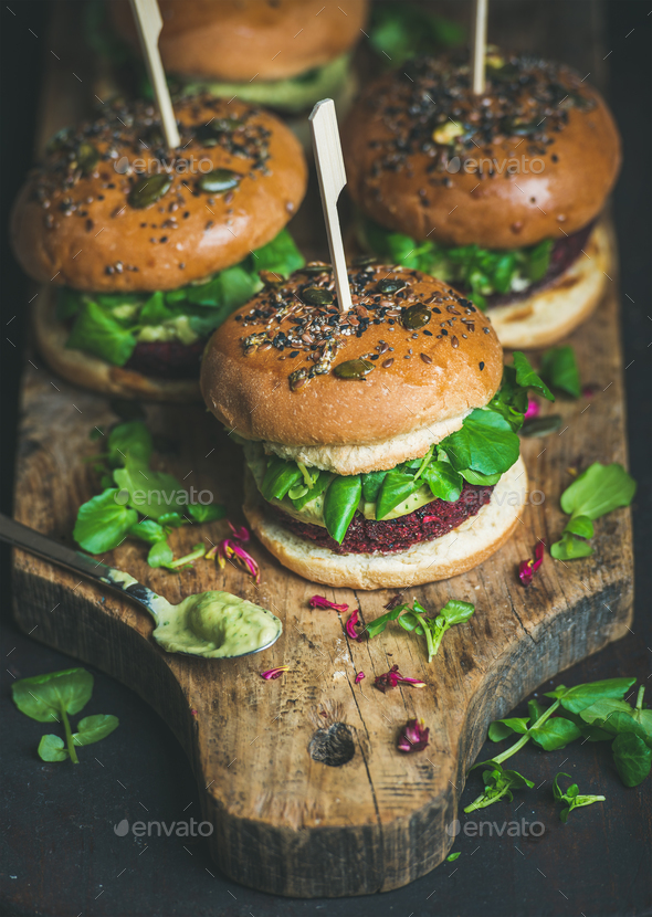 Healthy homemade vegan burger with beetroot-quinoa patty and avocado sauce - Stock Photo - Images