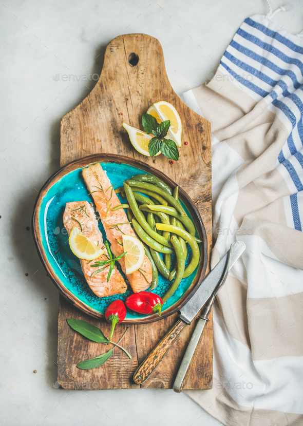 Roasted salmon fillet with lemon, rosemary, chilli pepper, green beans - Stock Photo - Images