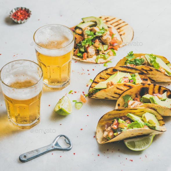 Healthy corn tortillas with beer in glasses over light background - Stock Photo - Images