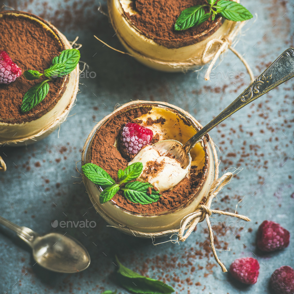Close-up of homemade Italian dessert Tiramisu with mint and raspberries - Stock Photo - Images