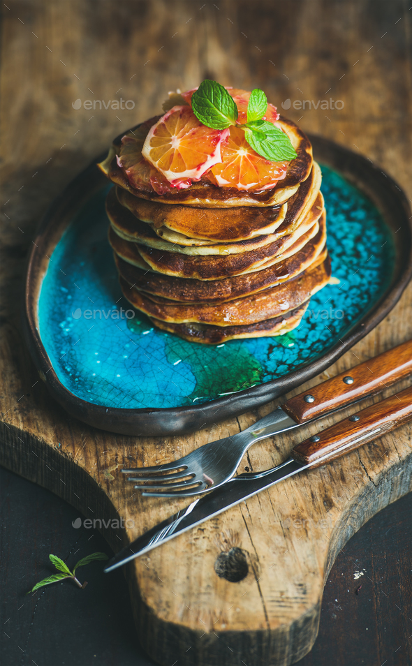 Homemade pancakes with honey, bloody orange slices and mint leaves - Stock Photo - Images