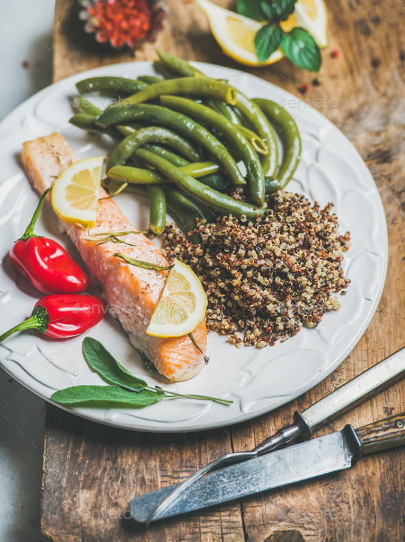 Roasted salmon with multicolored quinoa, chilli pepper and poached beans - Stock Photo - Images