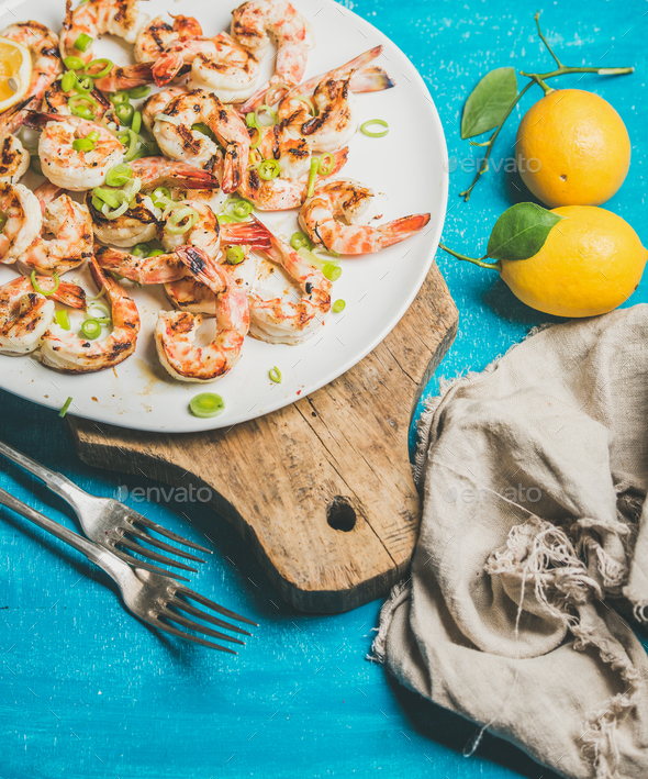 Grilled tiger prawns with lemon, leek and saucein white plate - Stock Photo - Images