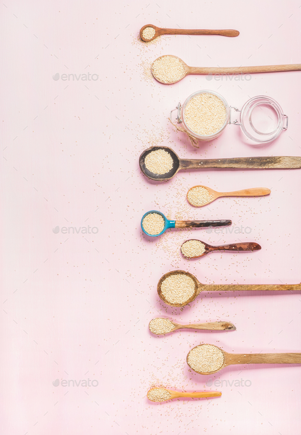 Quinoa seeds in different spoons and jar over pink background - Stock Photo - Images