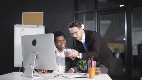 Сolleagues Communicate and Look at the Phone