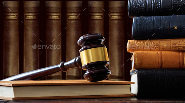 Judge gavel on a book, law books background, wooden desk Stock Photo by  rawf8