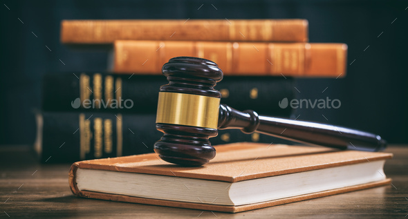 Judge gavel on a book, law books background, wooden desk Stock Photo by  rawf8