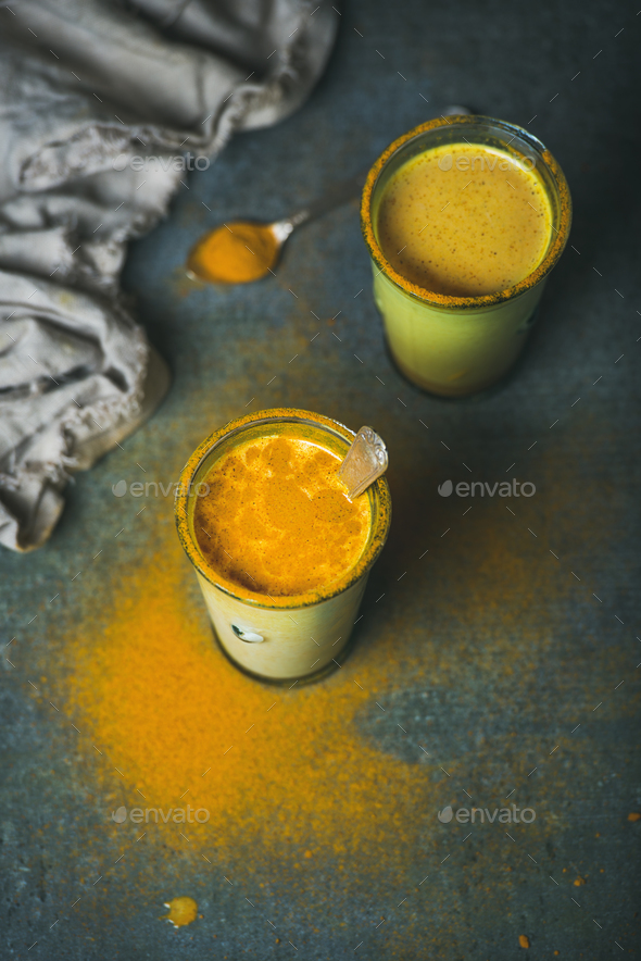 Golden milk with turmeric powder in glasses, energy boosting drink - Stock Photo - Images