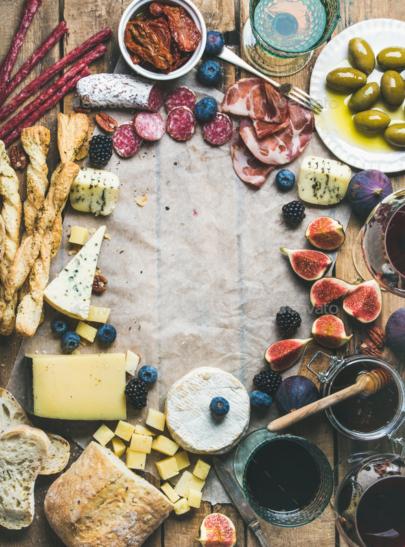 Wine and snack set with wines, meat, bread, olives, fruits - Stock Photo - Images