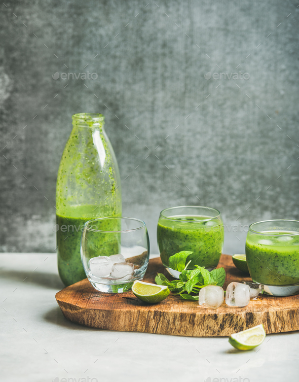 Fresh green smoothie with ice, mint and lime on board - Stock Photo - Images