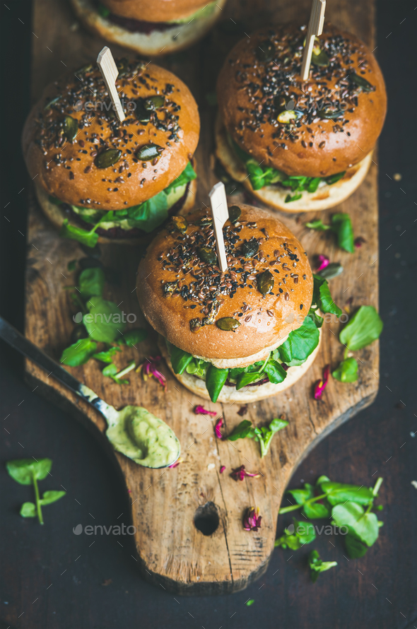 Healthy homemade vegan burger with beetroot-quinoa patty on wooden board - Stock Photo - Images
