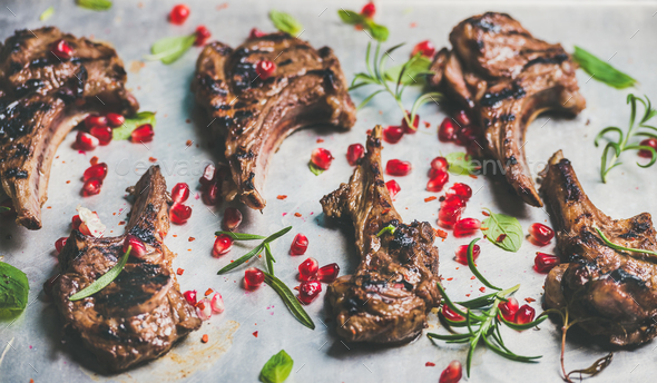 Grilled lamb ribs with pomegranate seeds and herbs - Stock Photo - Images
