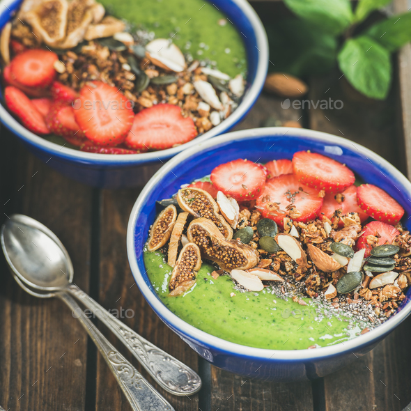 Healthy breakfast, Green smoothie bowls with granola, fruit, nuts - Stock Photo - Images
