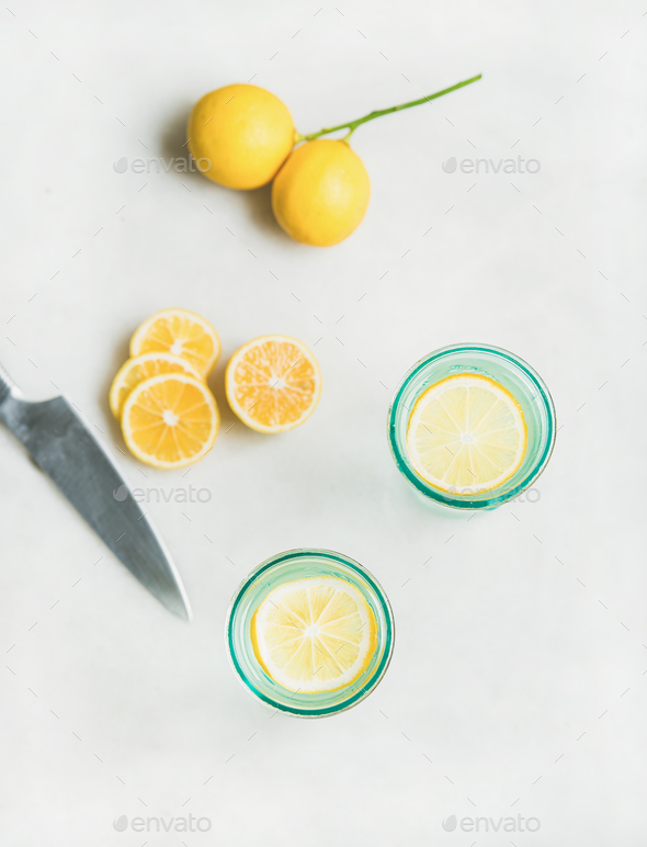 Detox lemon water in glasses and fresh lemons, top view - Stock Photo - Images
