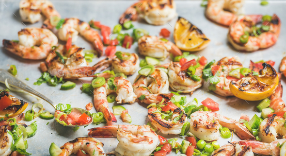 Close-up of grilled tiger prawns over grey background - Stock Photo - Images