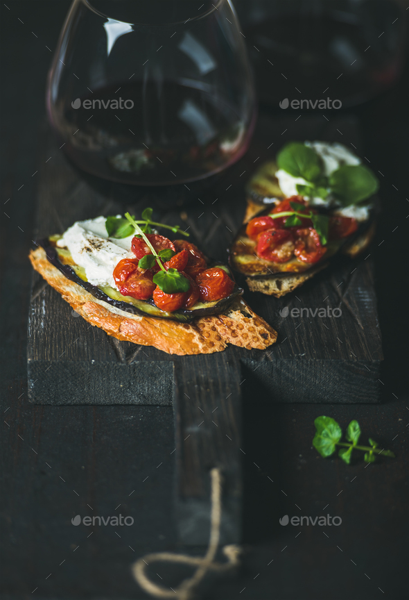 Red wine in glass and brushetta with vegetables, cream-cheese, arugula - Stock Photo - Images