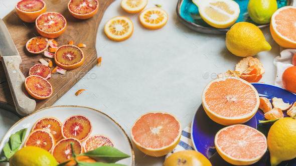 Natural fresh citrus fruits in ceramic plates and wooden board - Stock Photo - Images