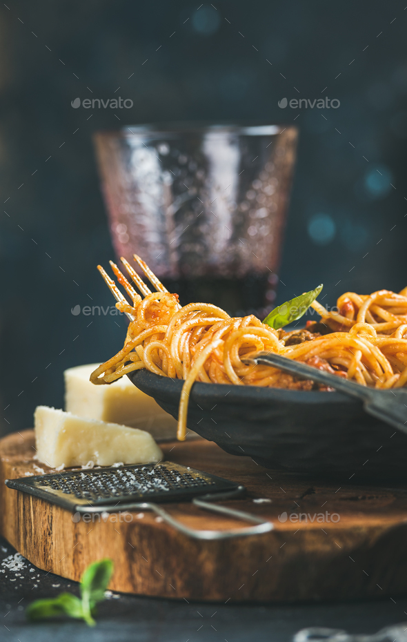 Spaghetti with meatballas, basil, parmesan cheese and wine in glass - Stock Photo - Images