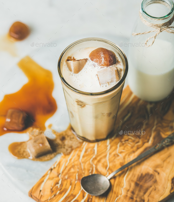 Iced caramel latte coffee cocktail with milk, frozen coffee cubes - Stock Photo - Images