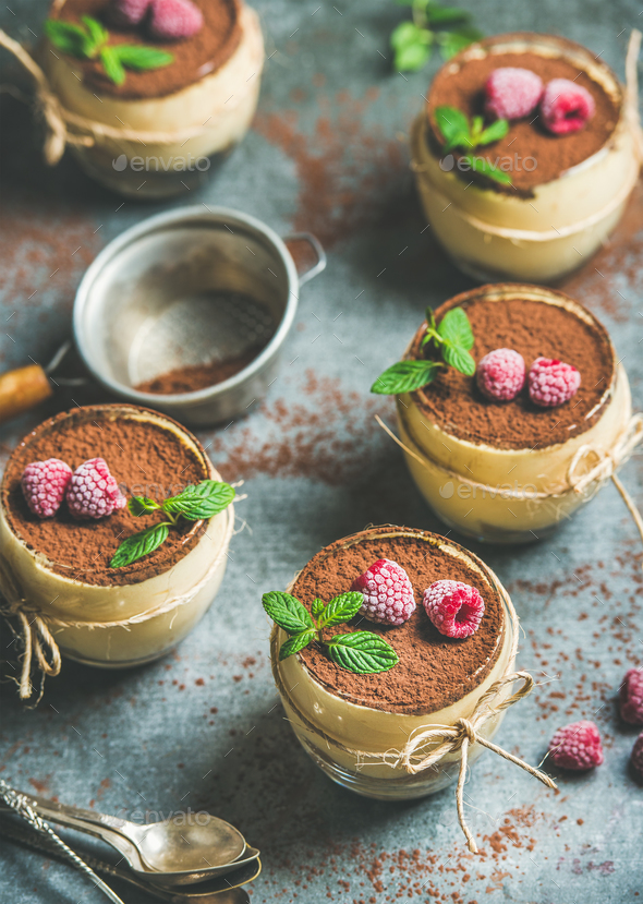 Homemade Tiramisu in individual glasses with frozen raspberries and mint - Stock Photo - Images