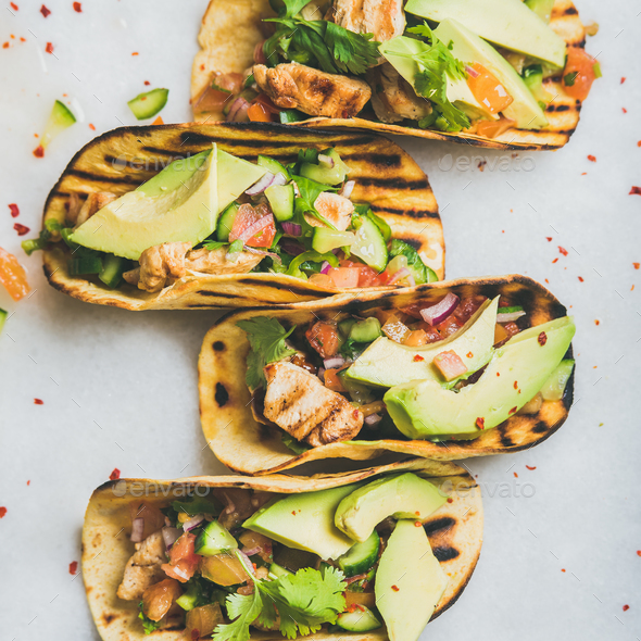 Healthy corn tortillas with grilled chicken fillet, avocado, fresh salsa - Stock Photo - Images