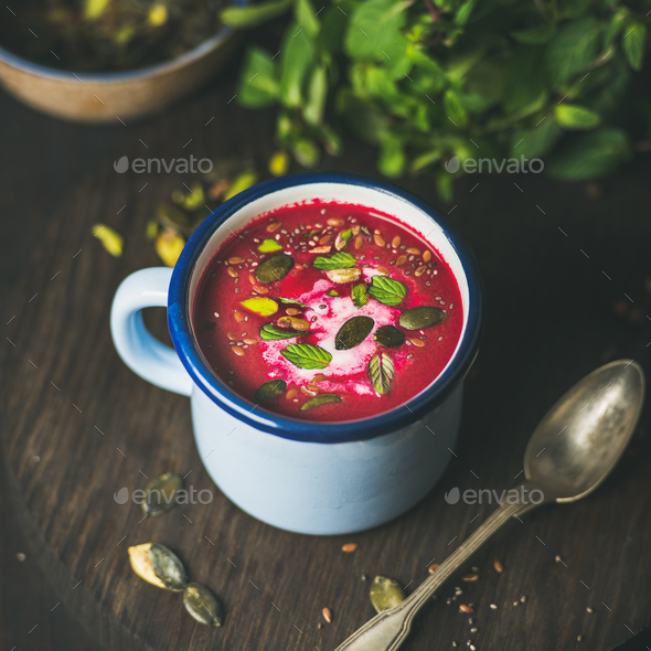 Spring beetroot soup with mint, pistachio, chia, flax, pumpkin seeds - Stock Photo - Images
