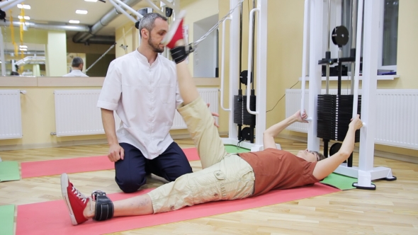 Physiotherapist Helping Elderly Woman 