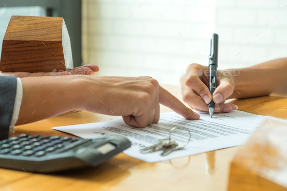 Buyers are signing a home purchase agreement from a broker. - Stock Photo - Images