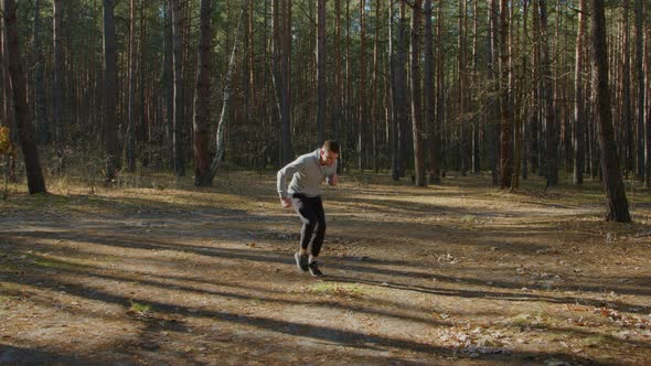 Man Practices High Knee Running
