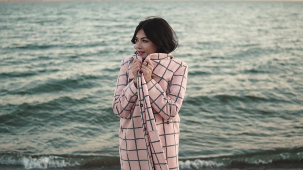Portrait of a Young Woman Who Is Hiding Coat From the Autumn Wind.