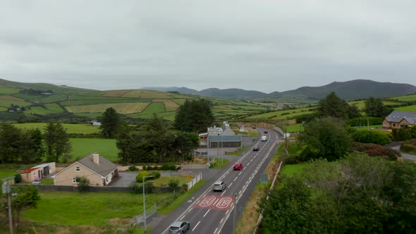 Forwards Tracking of Group of Vehicles Driving on Road and Passing Through Village in Countryside alt