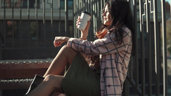 Portrait of a Cute Young Woman Against the Backdrop of an Autumn City. a Girl in an Autumn Coat alt