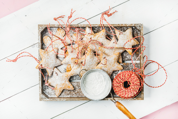 Christmas gingerbread star shaped cookies with sugar powder in tray - Stock Photo - Images