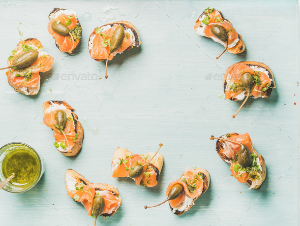 Crostini with smocked salmon, pesto sauce in glass, watercress, capers - Stock Photo - Images