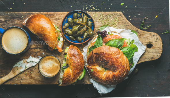 Breakfast with bagel, espresso coffee, capers on board, top view - Stock Photo - Images