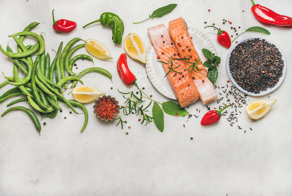Flat-lay of raw salmon fish fillet steaks with vegetables, greens - Stock Photo - Images