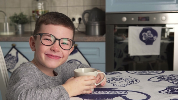 Little Boy Is Drinking Milk and Smiling