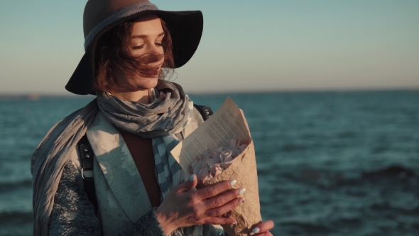 Portrait of Cute Charming Woman in Hat and Coat Against the Background of the Autumn Sea alt