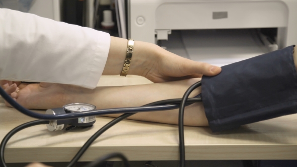 Doctor Measures Blood Pressure of Patient alt