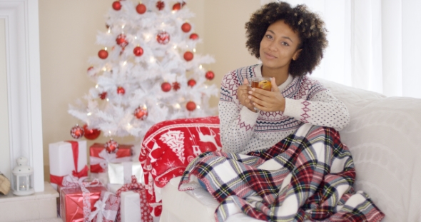 Young Woman Relaxing at Home Over Christmas