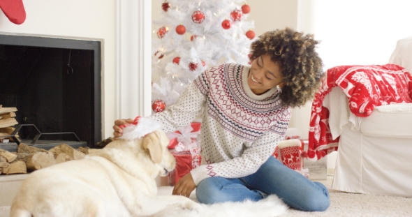Young Woman Relaxing with Her Dog at Christmas