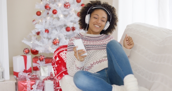 Young Girl Relaxing Listening To Christmas Music