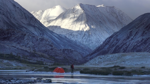 The Man Near the Tent on the Background of Mountain Landscape.
