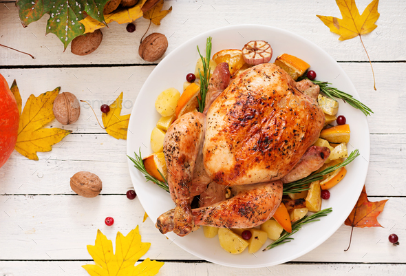 Roasted turkey garnished with cranberries on a rustic style table - Stock Photo - Images