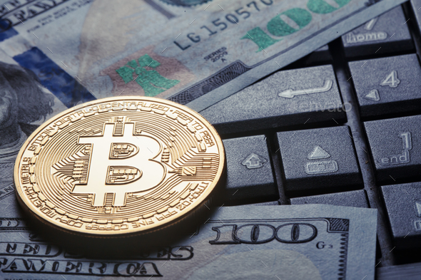Virtual currency bitcoin against the background of dollars and c - Stock Photo - Images