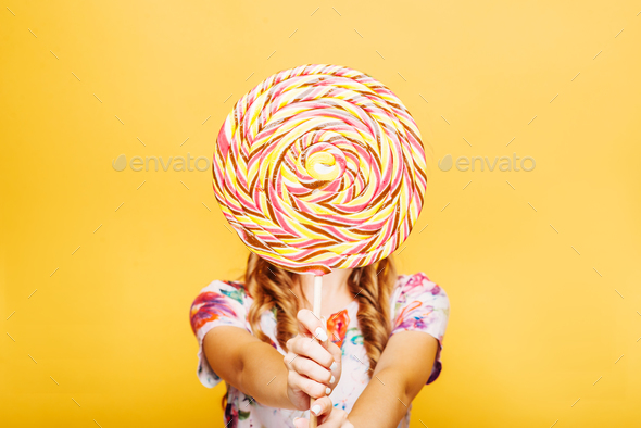 Woman with huge candy instead of a head - Stock Photo - Images