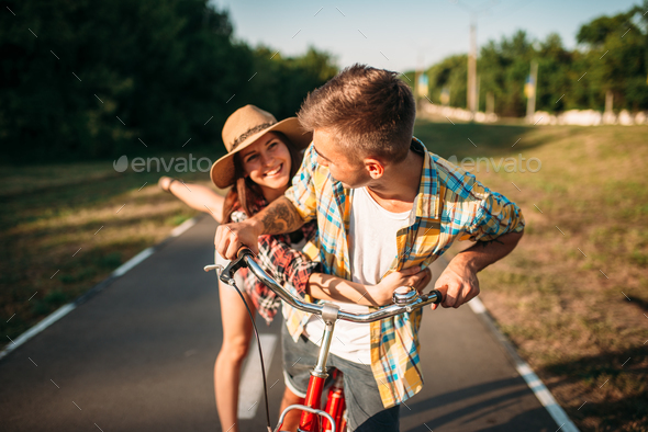 Love couple fun in summer park, vintage bicycle - Stock Photo - Images