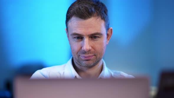 Closeup Portrait of Handsome Confident Caucasian Man with Laptop Looking at Camera alt