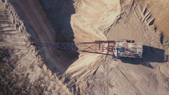 Flying Over the Excavator in a Quarry. Aerial Survey in alt