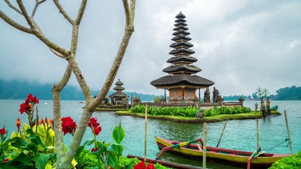 View Of Red Flowers And Temple Pura Ulun Danu Batur In Bali